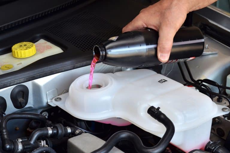 Mechanic pouring antifreeze or coolant to the engine, How Do You Check Antifreeze/Coolant Level?