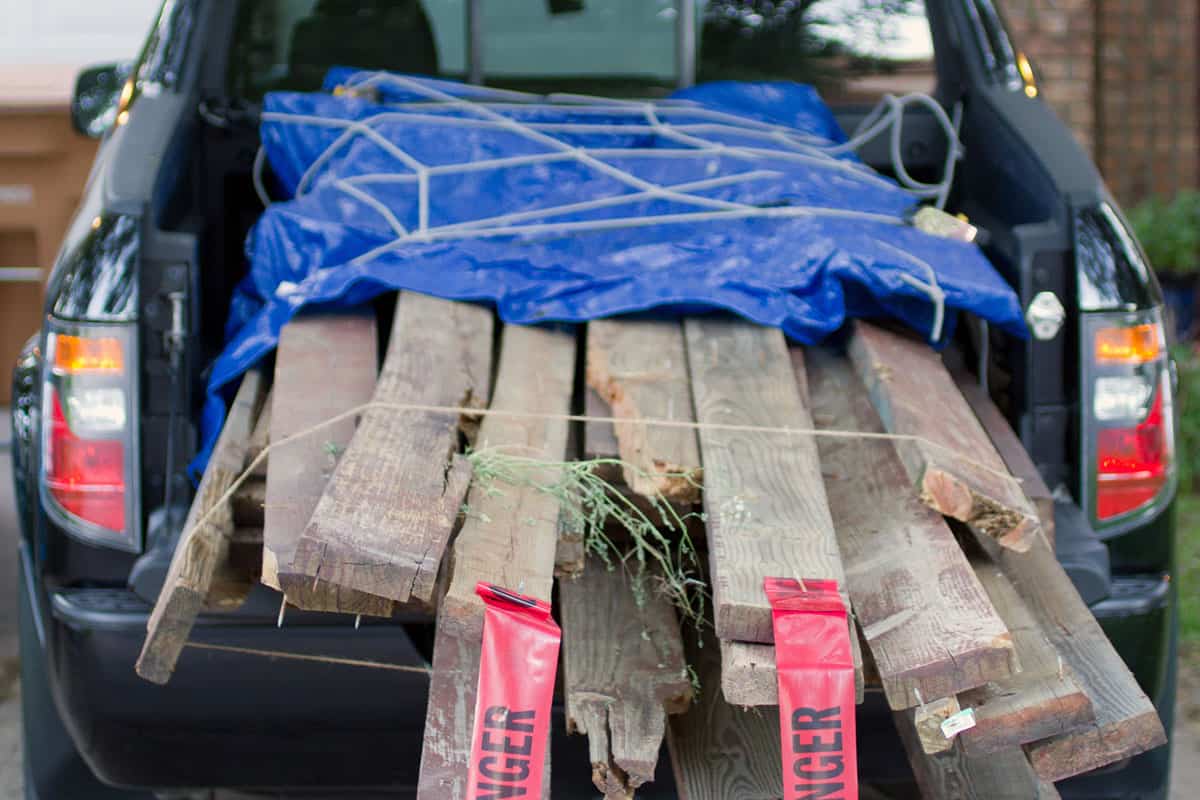 load of lumber demolition debris in the bed of a pickup truck