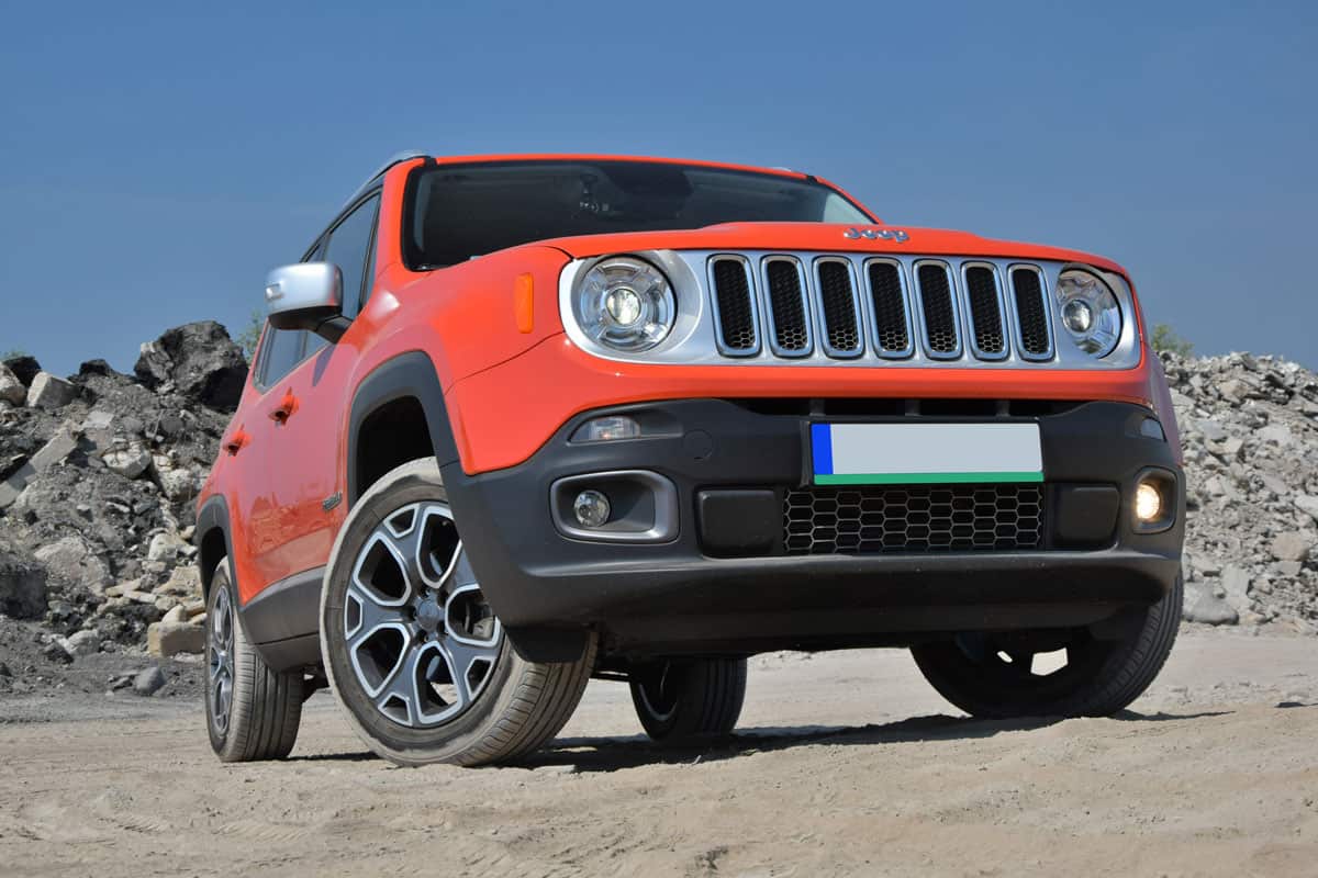 Brand new red Jeep Renegade photographed on a rocky terrain, How Many Miles Can a Jeep Liberty Last?