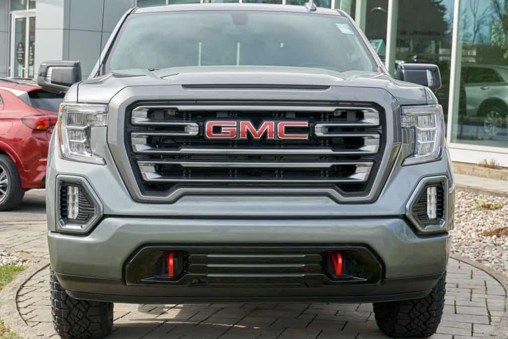 A huge GMC Canyon truck parked outside a car dealership