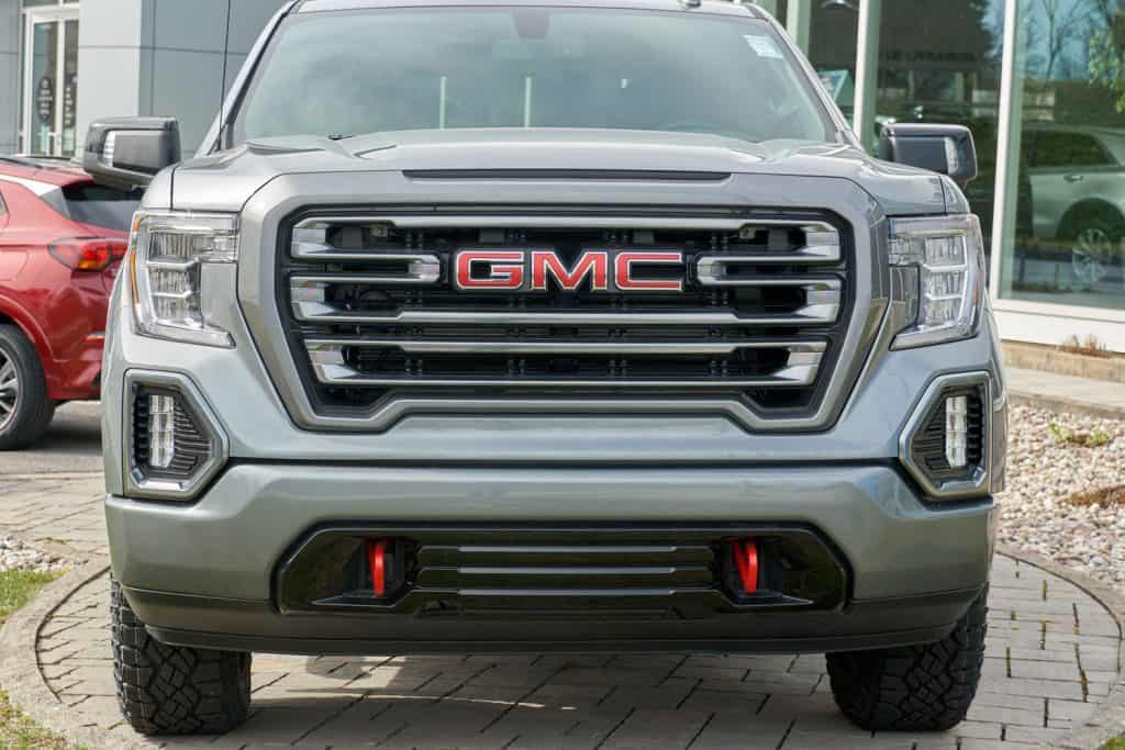 A huge GMC truck parked on a car dealership