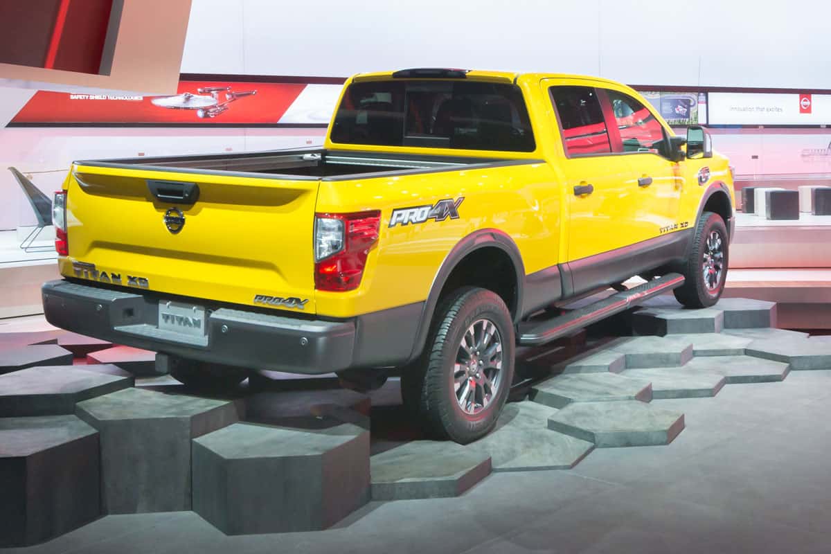Huge yellow Nissan Titan placed on an artificial octagon shaped terrain at a car show, Does Nissan Titan Have A Diesel Engine?
