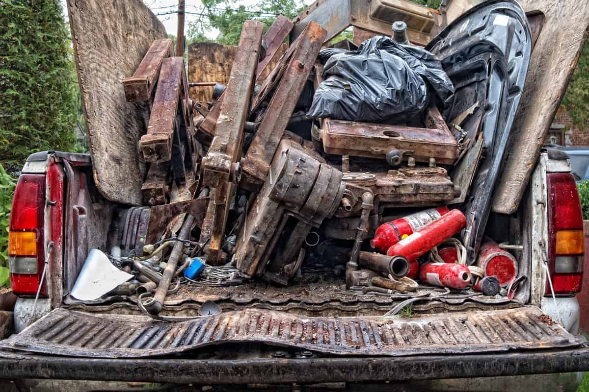 A truck filled with scrap metals on the truck bed