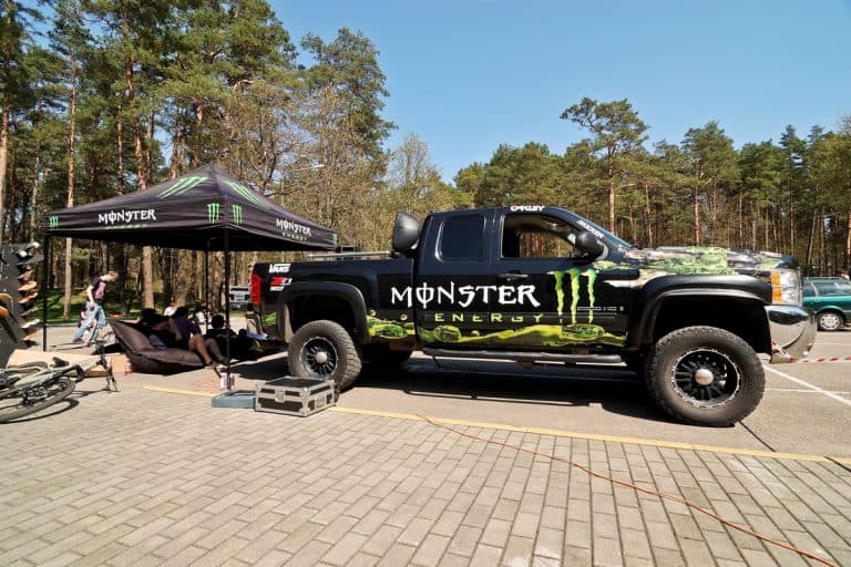 Monster Energy truck Chevrolet Silverado Z71 all covered with Monster Energy stickers parked at parking lot near Monster Energy tent , How Much Does A Chevrolet Silverado Weigh?