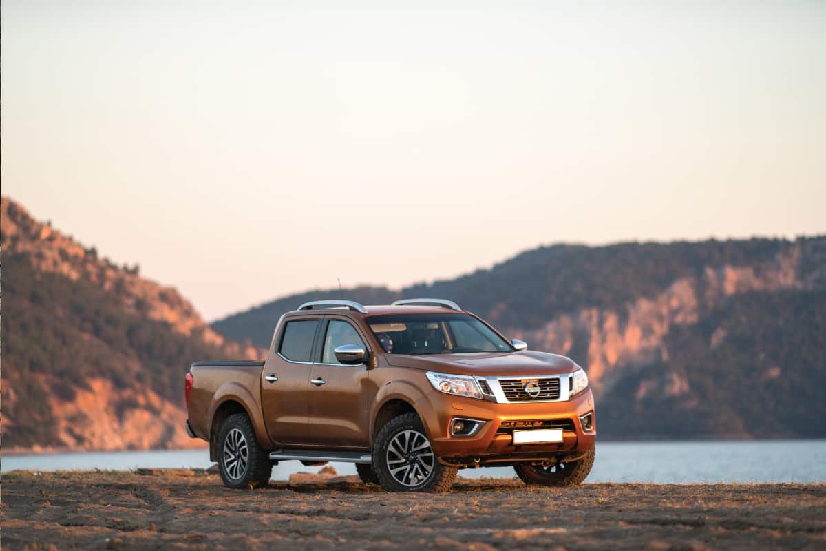 Nissan NP300 Frontier stopped on the beach, How Long Is A Nissan Frontier? (For Various Bed Lengths)