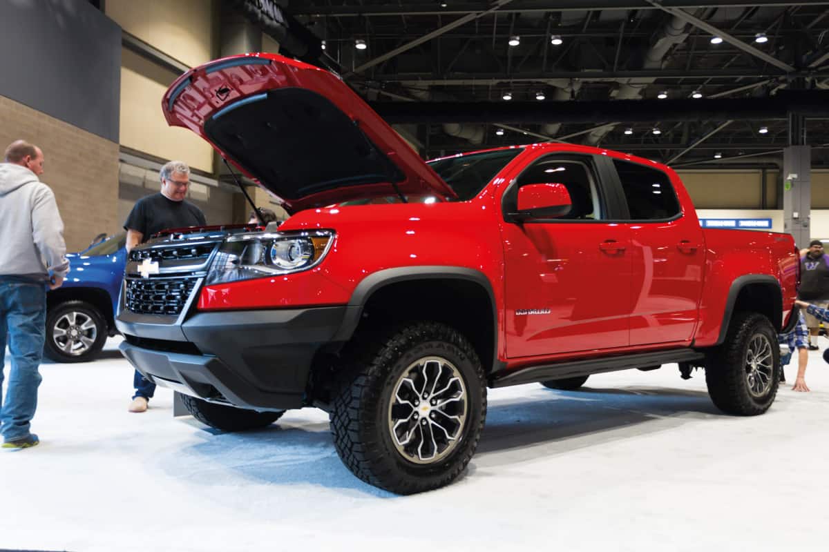 Red Chevrolet Colorado in a car show inspected by clients, Can The Chevy Colorado Be Flat Towed?