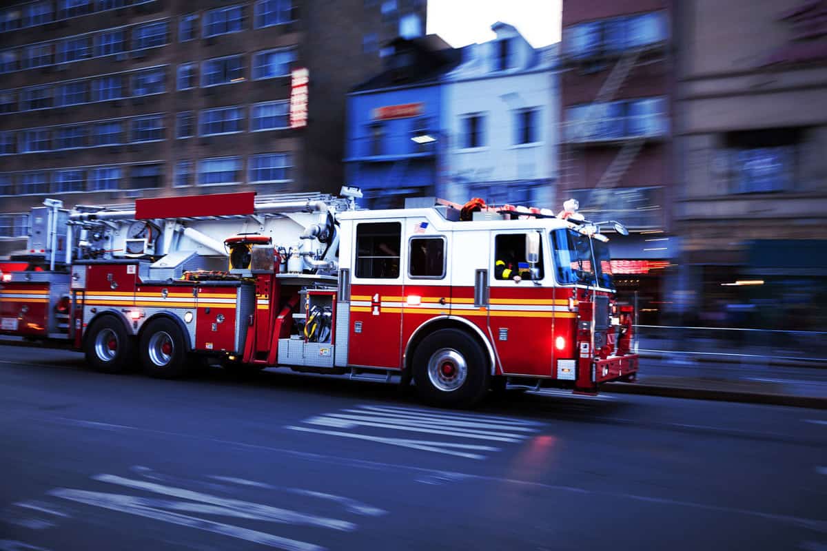 A firetruck travelling to the scene of accicdent, Why Are Fire Trucks Red? [Amazing Facts and Myths!]