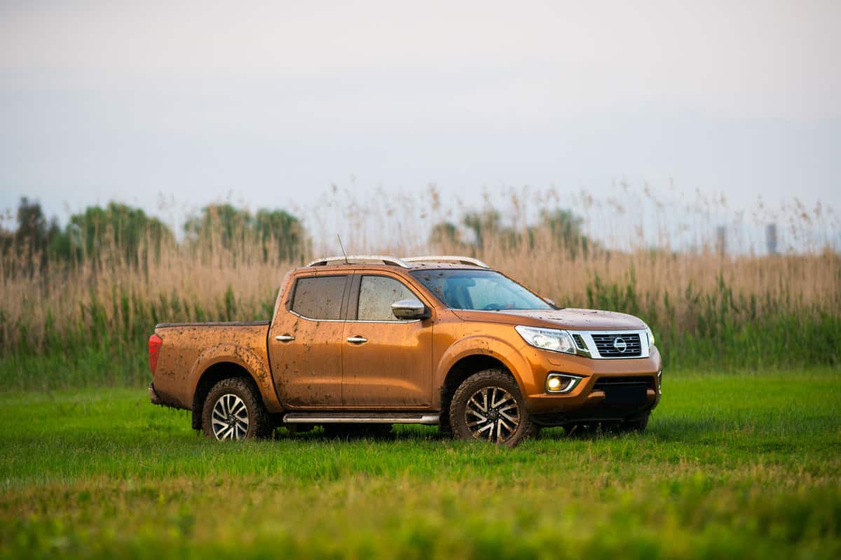 A Nissan Frontier pickup truck trekking on a muddy field, Can A Nissan Frontier Tow A Travel Trailer?