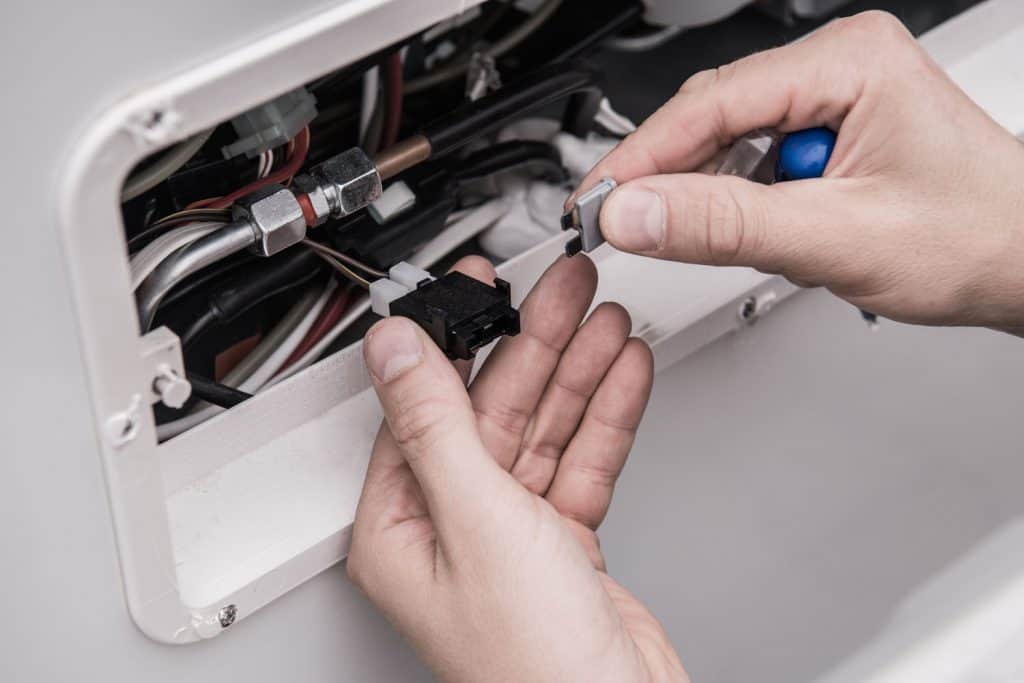 A man checking the appliance fuse of his RV