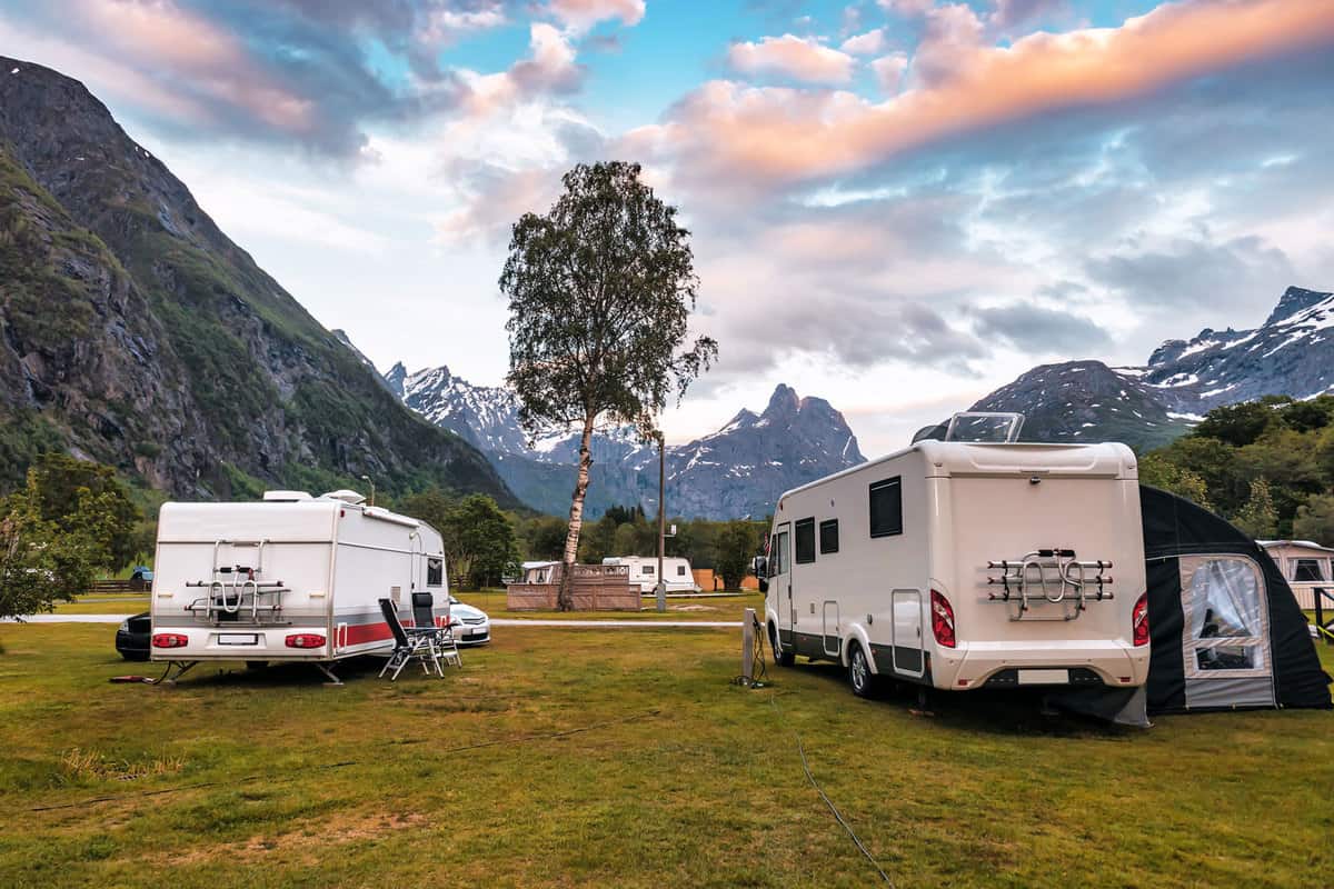 Two RVs parked outside a camping ground with a panoramic view of the mountain range, RV Water Pump Runs But No Water - What To Do?
