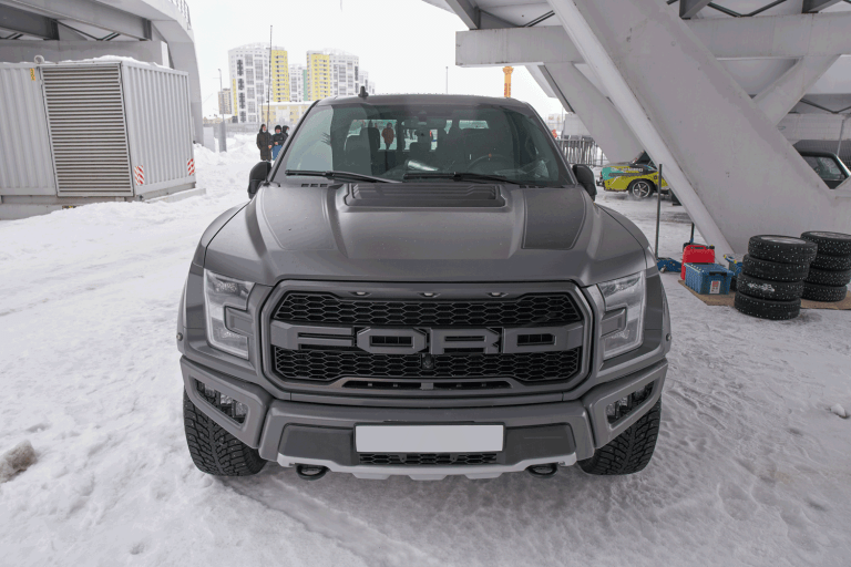 A Ford F-150 Raptor parked outside a Stadium, A Look Into The 15 Ford F-150 Colors [With Pictures!]