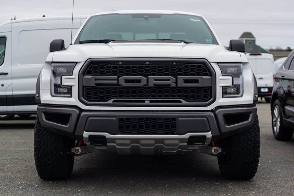 A huge white colored Ford F-150 raptor on a parking lot
