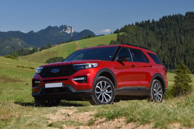 Ford Explorer V6 Plug-in Hybrid stopped on a road in mountain scenery. Rapid Red, 2021 Ford Explorer Color Options