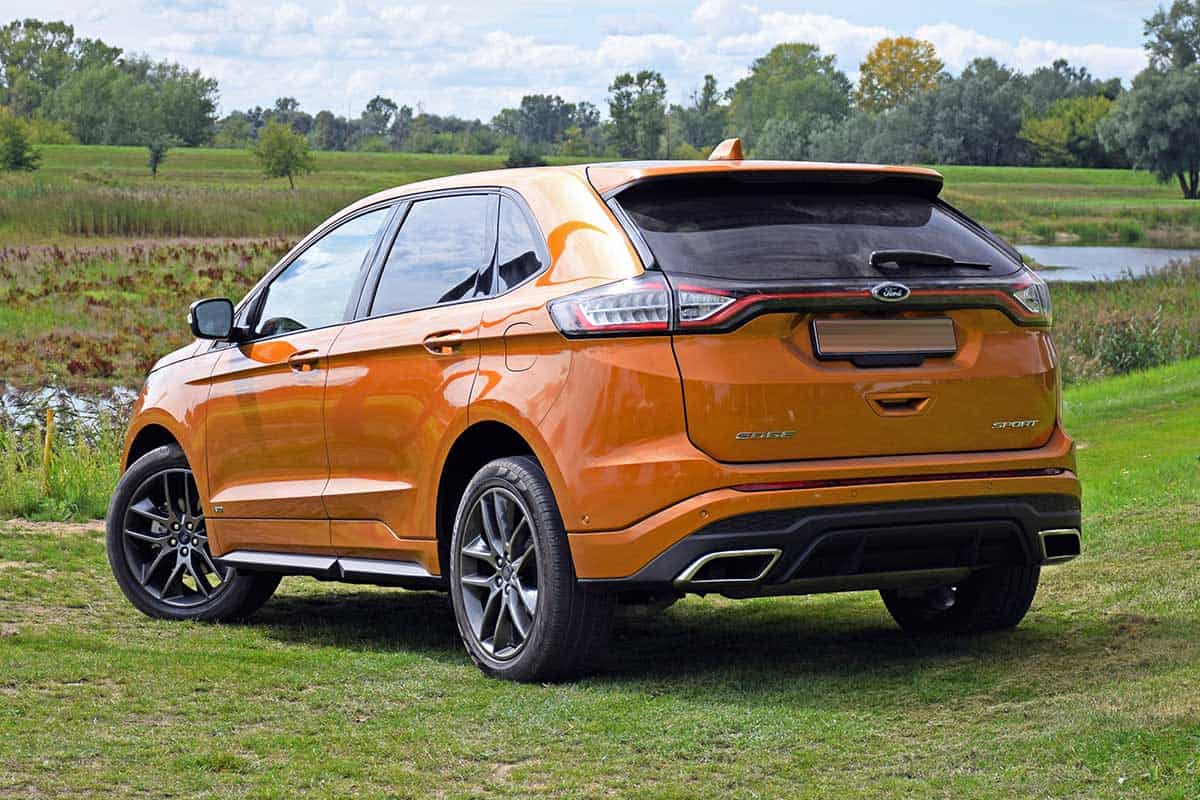 2016 Ford Edge stopped on the grass, How Big Is The Ford Edge Cargo Area? [Dimensions For 2021 Models]