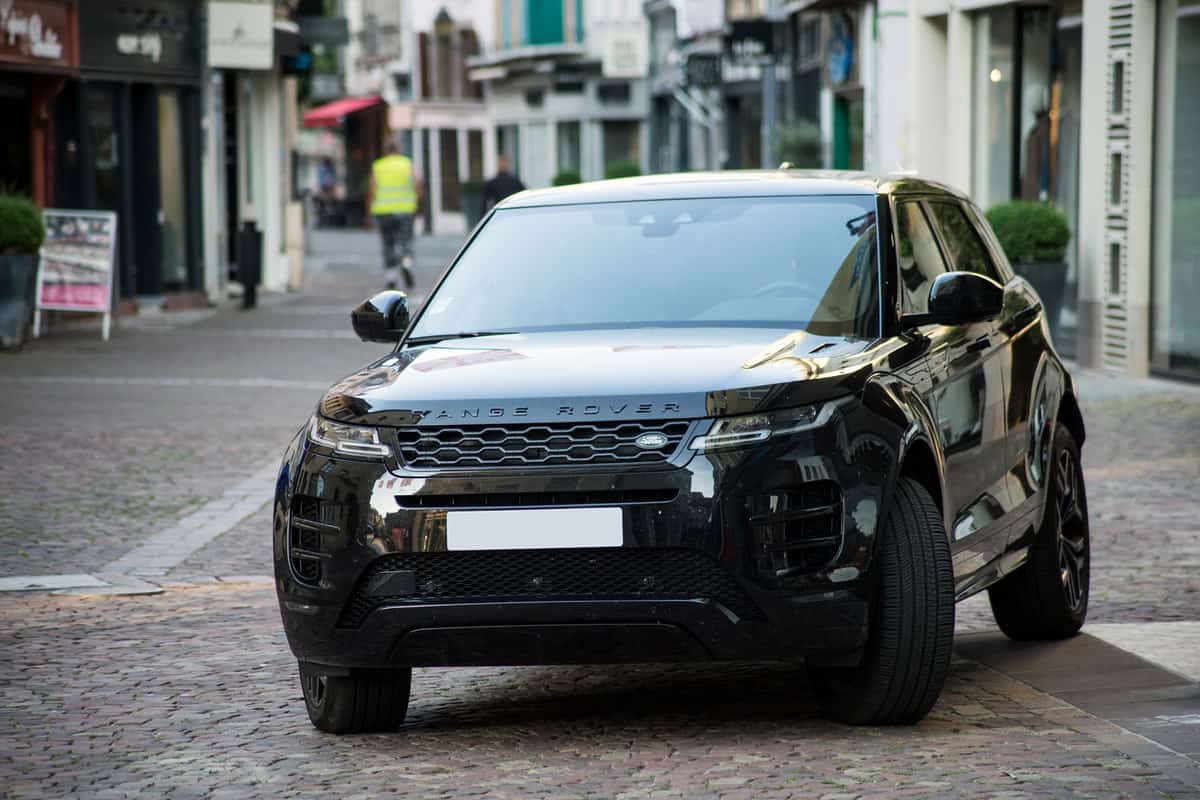 A Range Rover Velar moving on the streets on a busy road, What SUVs Have Blind Spot Detection? [2021 Midsize And Full-Size]
