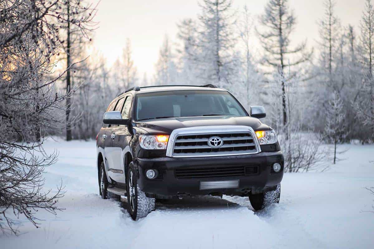 Black off-road vehicle Toyota Sequoia in the snow covered forest