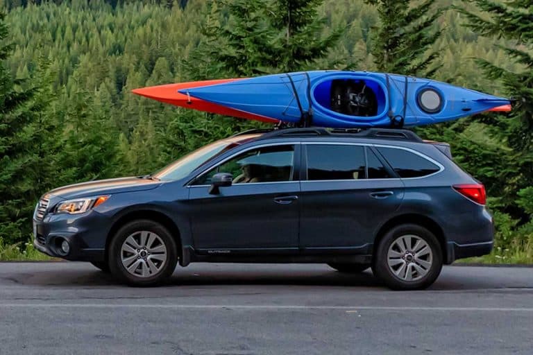 SUV with kayaks in front of mountain during sunset, What Are The Best Kayak Racks For Pickup Trucks? [6 Options Explored!]