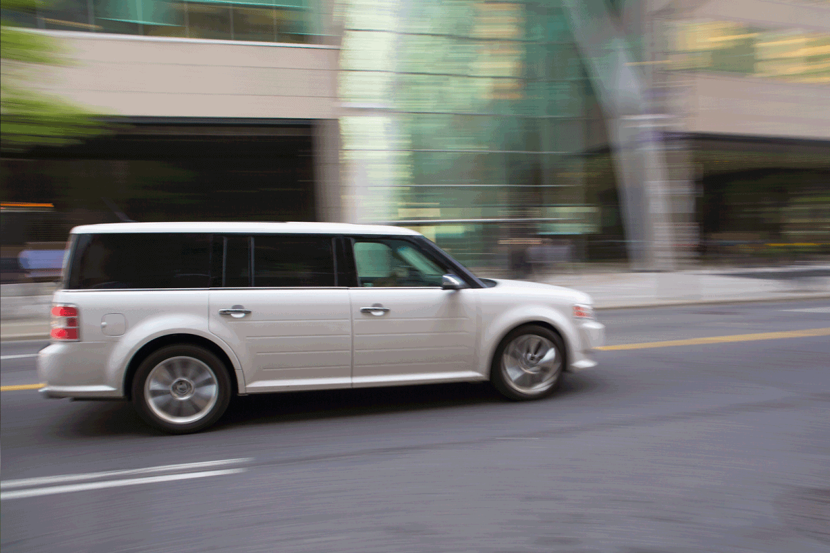 White Ford Flex CUV (Cross Over Utility Vehicle), speeding in Toronto. What Are The Ford Flex Cargo Dimensions