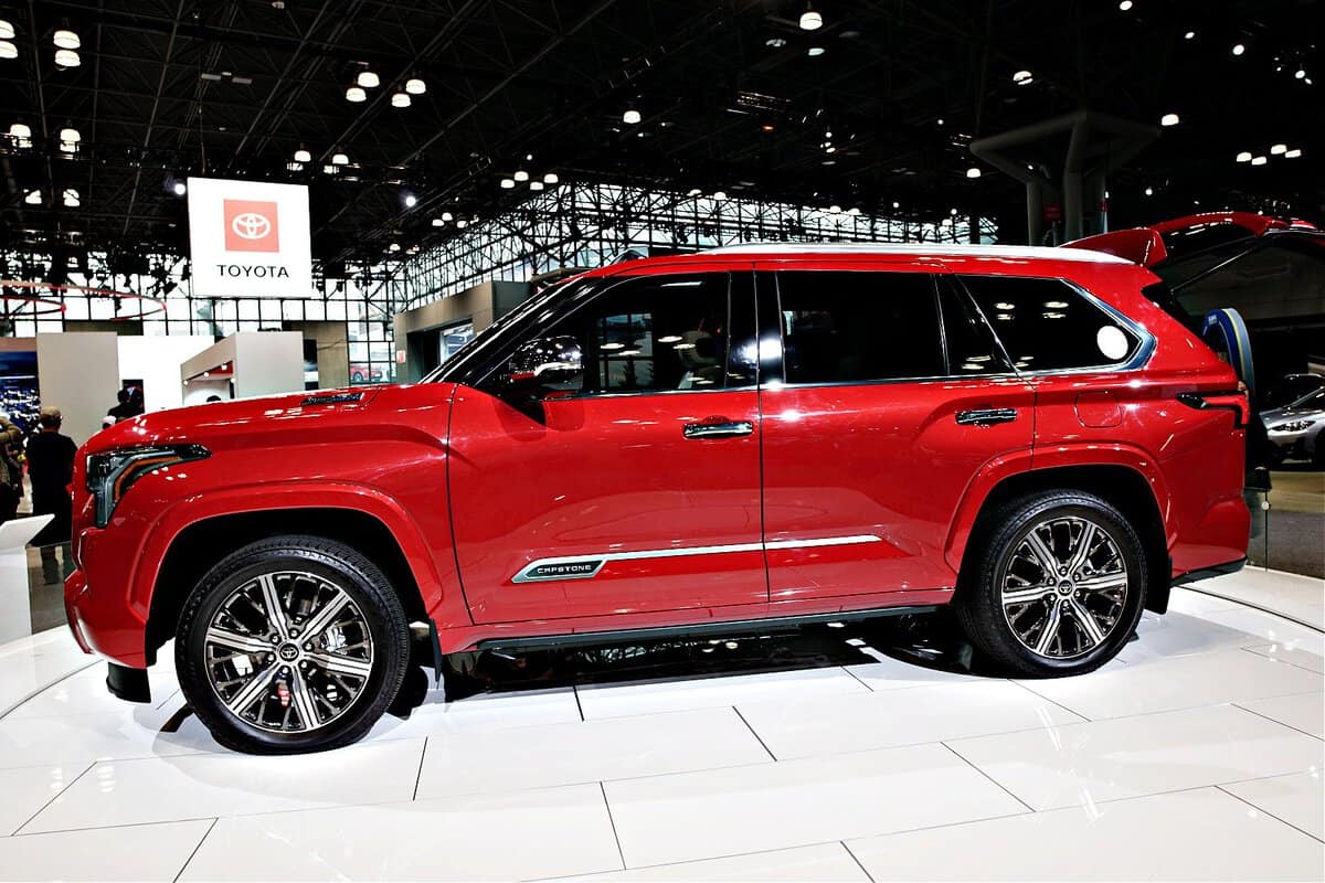 A red 2023 Toyota Sequoia SUV on display indoor at the 2022 New York International Auto Show on April 23, 2022 in New York City. The new full-size SUV showcases a redesigned exterior with black accents and new Toyota branding on the grille.