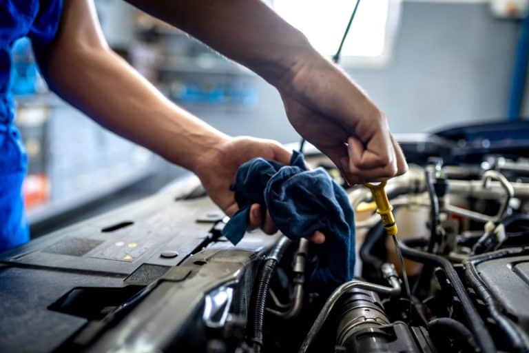 A mechanic checking the engine of car, How Fast Does Fuel Injector Cleaner Work?