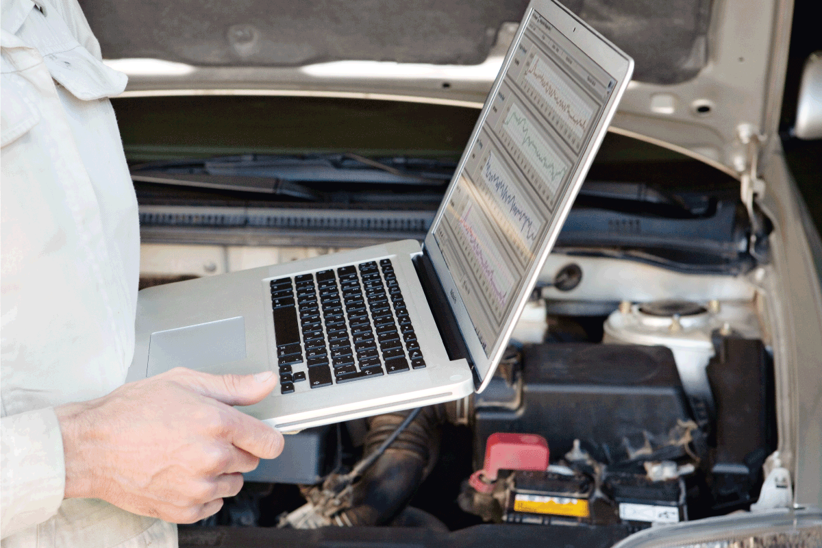 Car mechanic with laptop. How Long Does A Car's ECU Last