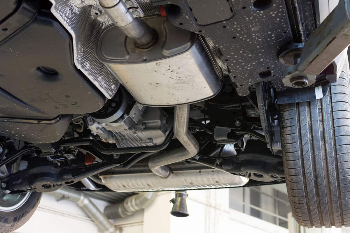Catalytic converter. Car on a lift in a car service. View of the car from below, Clogged Catalytic Converter - How To Tell And What To Do?