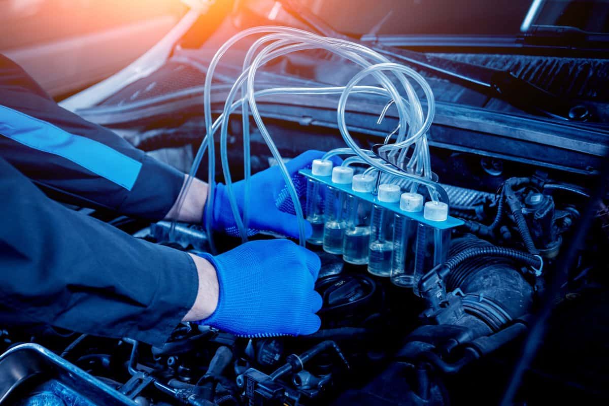 Cleaning engine injectors. Car repair. Service station.