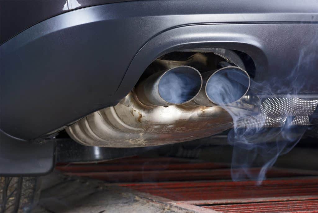Smoke emission from exhaust pipe of car.