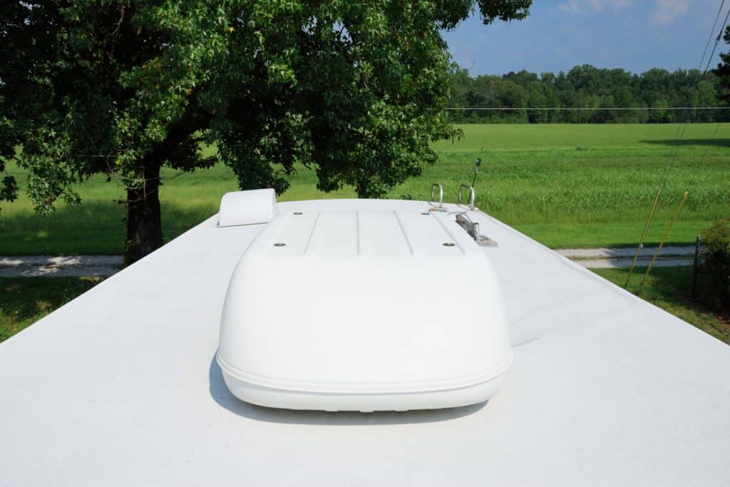 A large air-conditioning unit on top of the RV