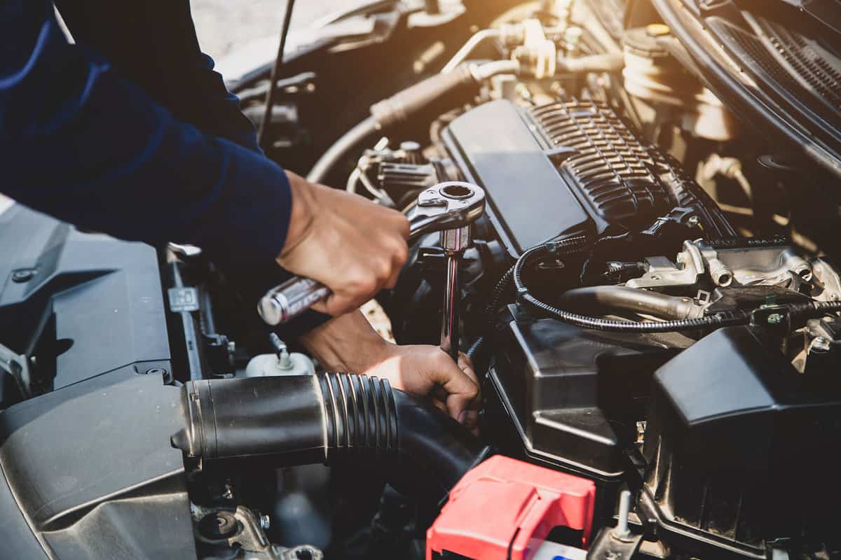 Auto mechanic hands using wrench to repair a car engine. concepts of car insurance support and services, Why Does My Car Feel Heavy And Sluggish?