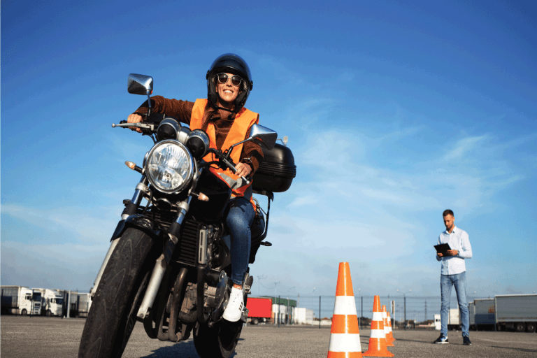 Female student with helmet taking motorcycle lessons and practicing ride. How To Get A Motorcycle License In Florida