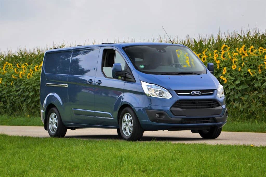 Ford Transit Custom stopped on the road. This model is one of the most popular delivery vans in Europe, How Much Weight Can A Ford Transit Carry?