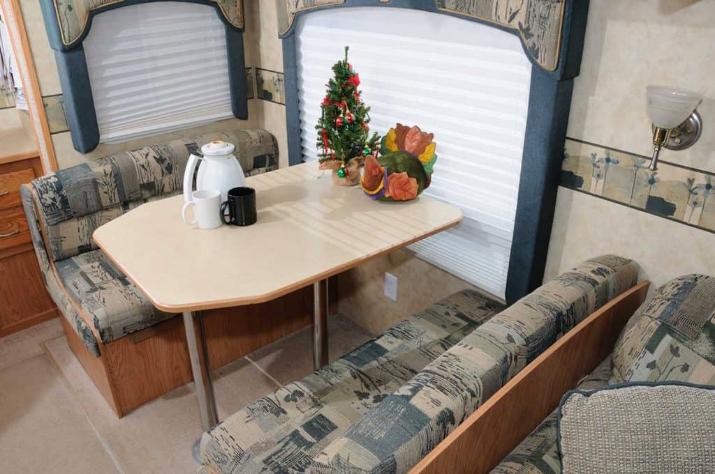 RV table with coffee mugs and pot with holiday decorations