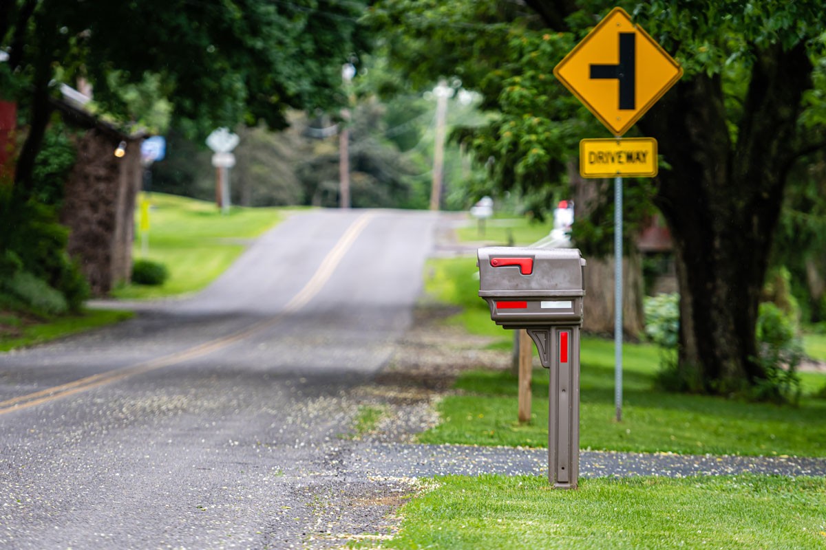 traditional american mailbox on side walk village