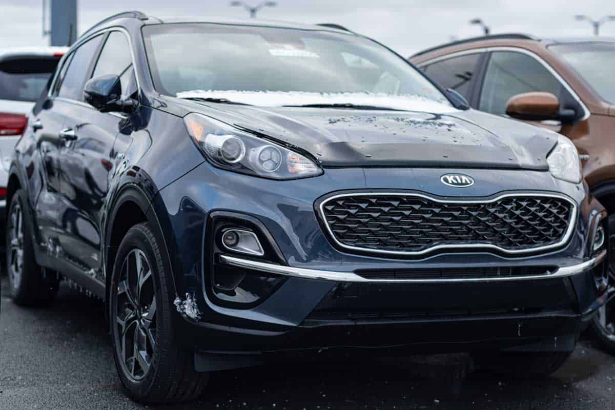 A 2020 Kia Sportage SUV parked at a dealership, How To Remove The Jack From Kia Sportage
