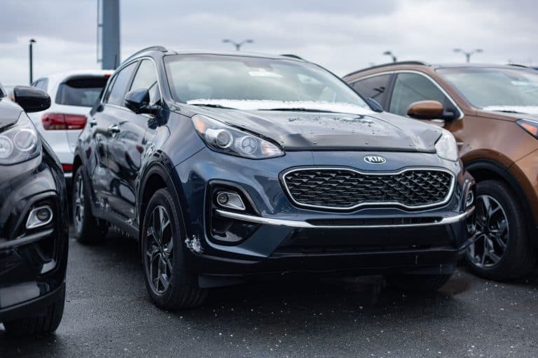 A 2021 black Kia Sportage photographed on the parking lot