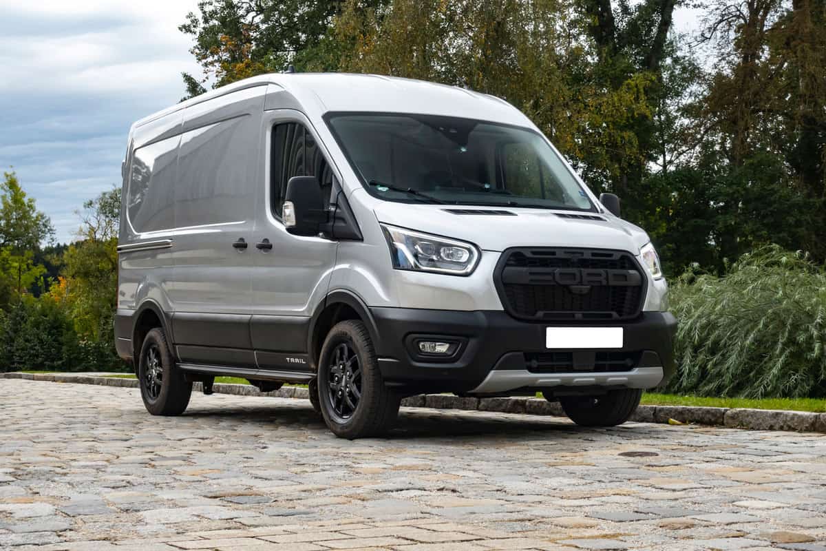 A grey 2020 model Ford transit van parked on the side of the road