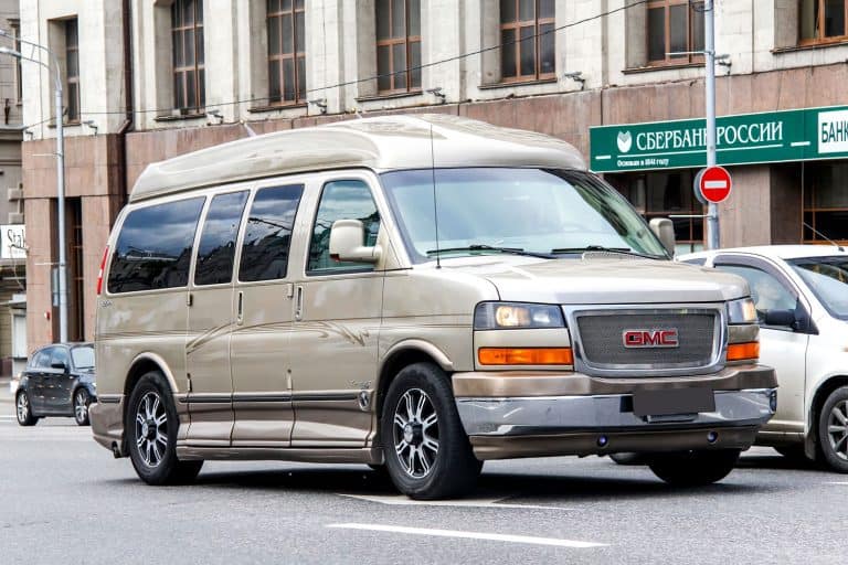 A huge brown color GMC Savana moving on the streets, Can You Stand Up In A GMC Savana?