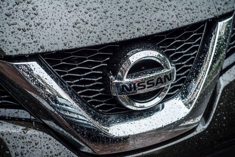 A Nissan Emblem soaked in rain, Is The Nissan NV AWD Or FWD?