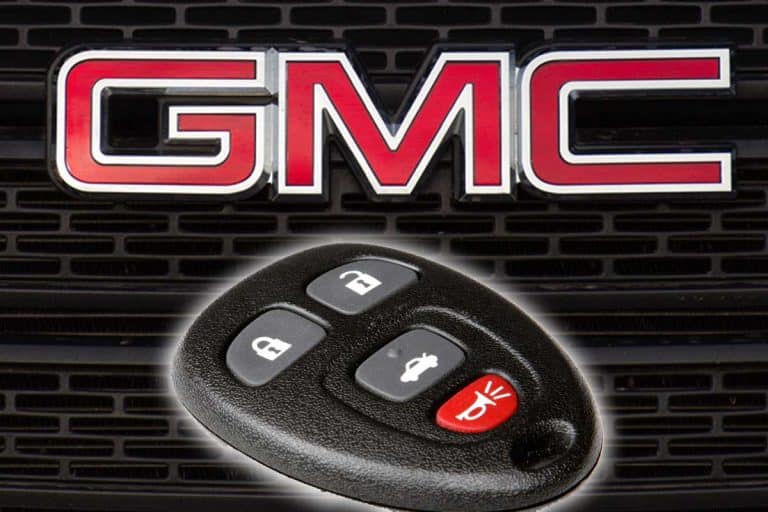 A smart key with GMC logo and grille on the background, How To Program A GMC Savana Key