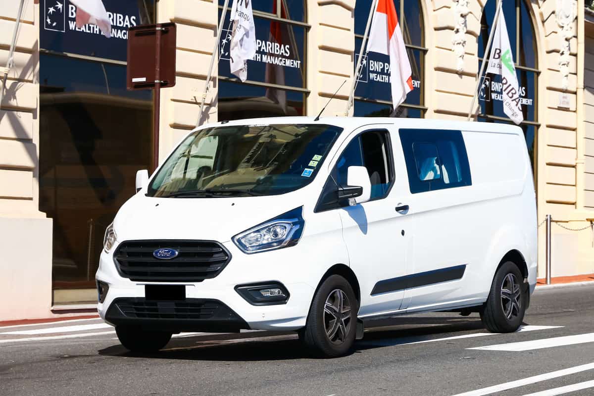 A white Ford Transit parked on the side of a building, Do Ford Transit Seats Fold Flat? Are They Removable?