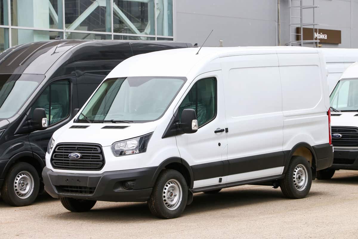 Brand new white cargo van Ford Transit in a city stree