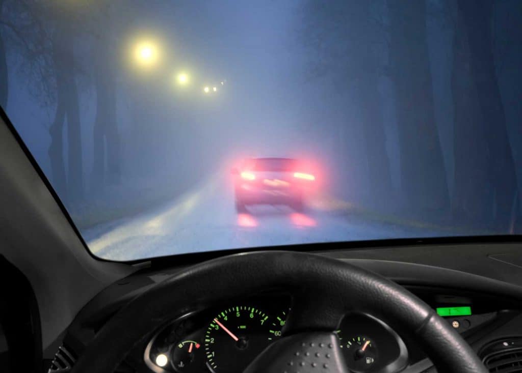 Car in foggy road