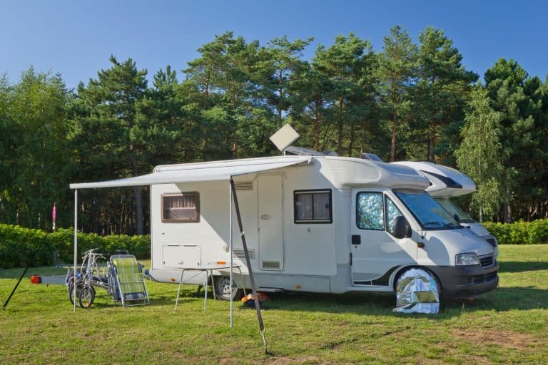 Two motorhome parked next to each other with its awning deployed and chairs set up outside, 11 Great RV Awning Ideas