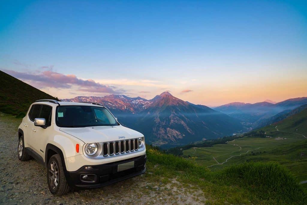 White Jeep Renegade parked on dirt road