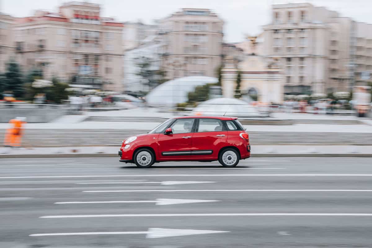 A red Fiat 500L moving along the highway, 4 Best Oils For A Fiat 500L [With Other Oil Changing Tips!]