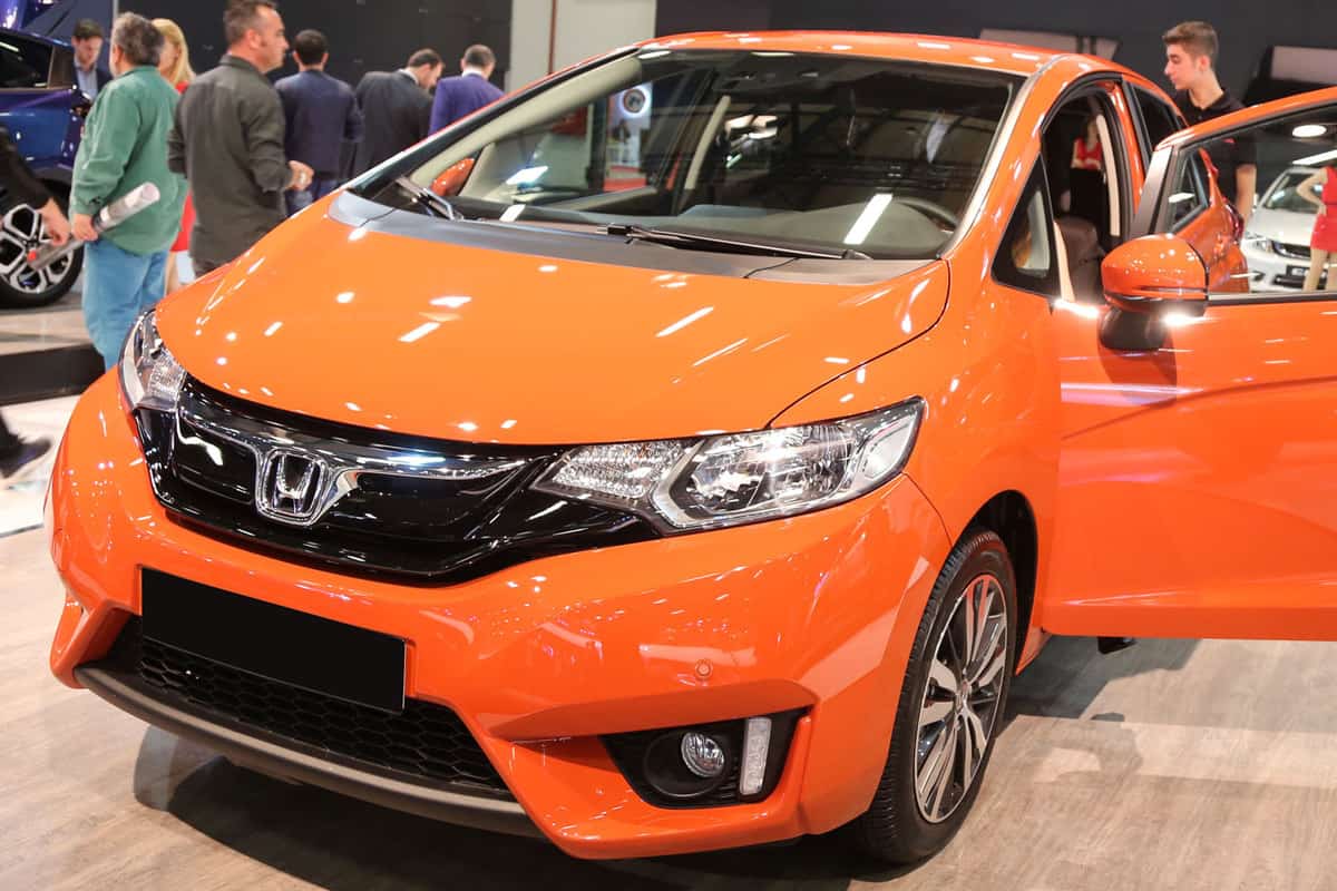 An orange colored Honda Fit displayed at the car show, How To Start Honda Fit Without Smart Key