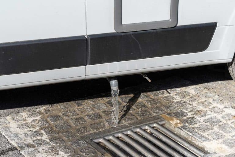 Close up view of proper disposal of gray water and waste water from a camper van at an RV park, How Often Should You Empty Gray Water Tank?