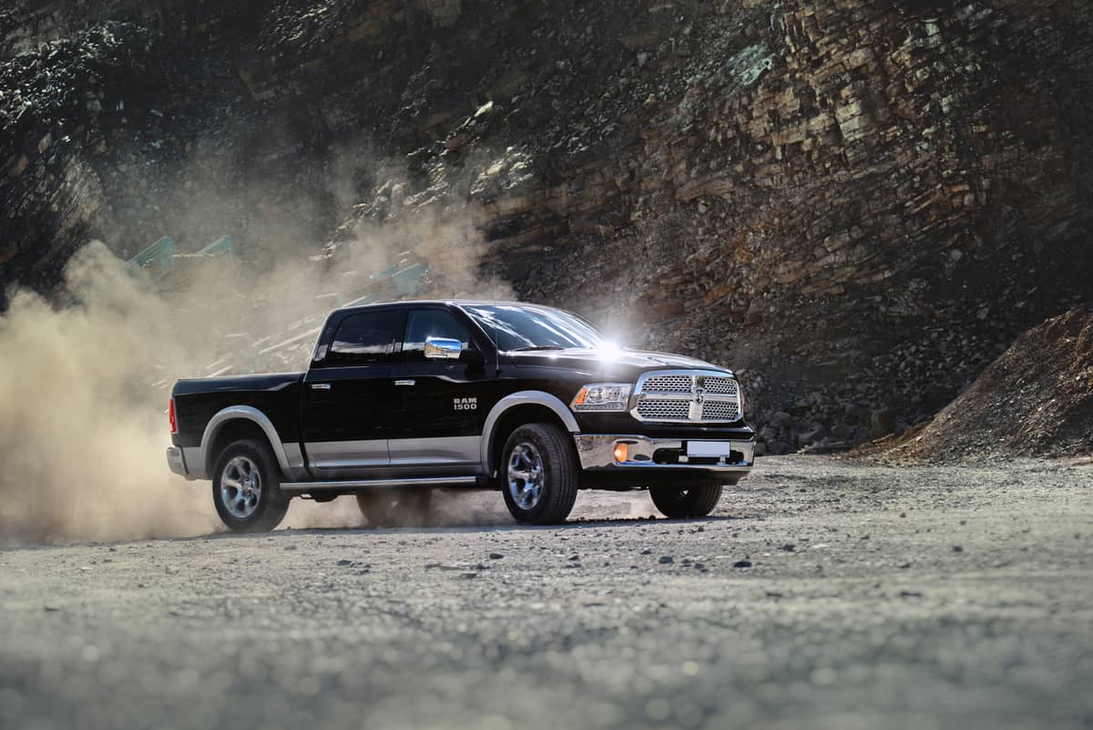 Dodge RAM 1500 with dust swirling from the quarry in which it is driving