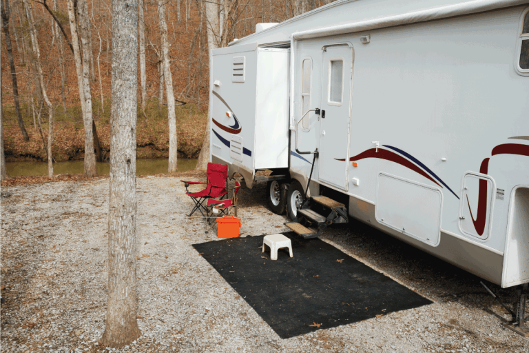 Fifth-wheel-travel-trailer-at-gravel-creekside-campsite.-RV-Electric-Steps-Not-Working---What-to-Do